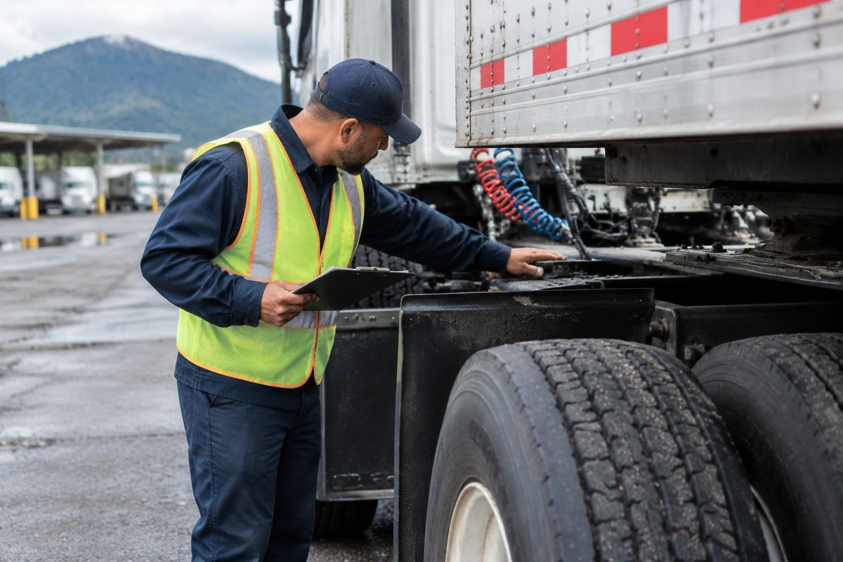 Commercial carrier driver performing safety and equipment inspection in Mountain View.