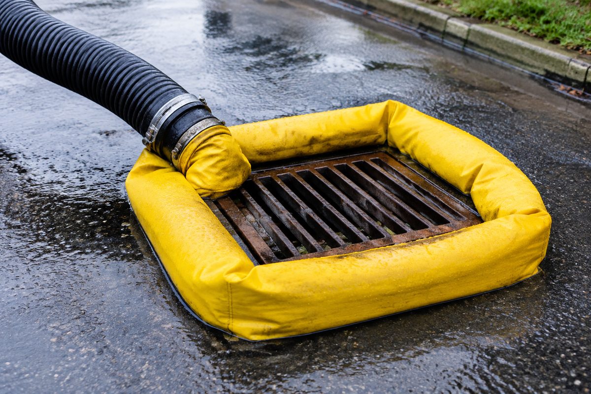 Environmental containment berm preventing wash runoff from entering storm drain.